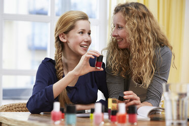 Female teenager choosing nail varnish - STKF001046