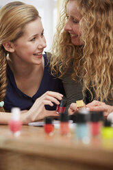 Female teenager choosing nail varnish - STKF001047