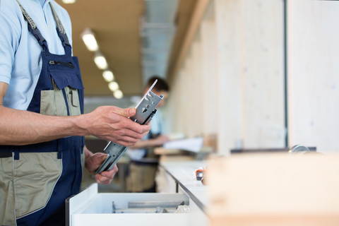 Craftsman holding piece of metal stock photo