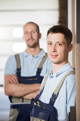 Portrait of two craftsmen on shop floor - FKCF000046