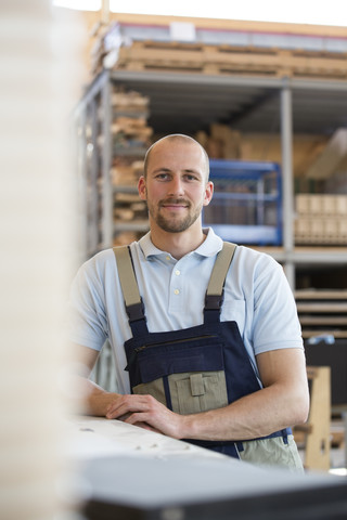 Smiling craftsman on shop floor stock photo