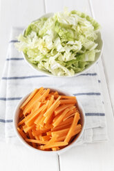 Sliced carrots and Chinese cabbage in bowls for a wok dish - EVGF000670
