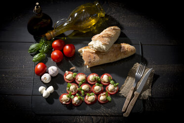 Slices of mozzarella cheese, tomatoes and basil herb - MAEF008679