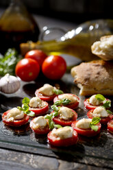 Slices of mozzarella cheese, tomatoes and basil herb - MAEF008680