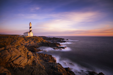 Spain, Balearic Islands, Menorca, Cap de Cavalleria, lighthouse at sunrise stock photo