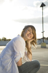 Happy teenage girl on parking lot - FKF000583