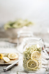 Einmachglas mit Holunderblüten, Sambucus nigra, Zitronenscheiben und Zucker zur Herstellung von Holunderblütensirup - SBDF000949