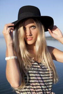 Portrait of young woman wearing black hat - FAF000021