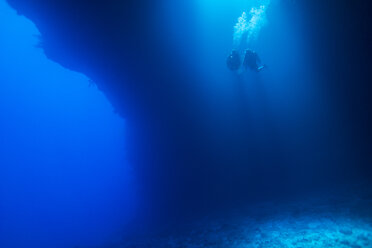 Palau, Pacific Ocean, two scuba divers in underwater cave - JWAF000153