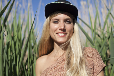 Portrait of smiling young woman wearing baseball cap stock photo