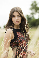 Portrait of young woman standing on a meadow - UUF001302