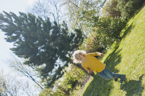 Boy running in garden stock photo