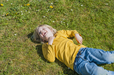 Laughing boy lying in meadow - MJF001317