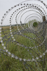 Germany, Bavaria, Oberpfaffenhofen, Barbed wire fence at airport - CRF002597