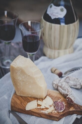 Italian cheese Grana Padano, Salami, two glasses and bottle of Chianti - SBDF000994