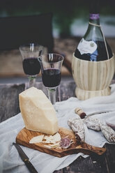 Italian cheese Grana Padano, Salami, two glasses and bottle of Chianti - SBDF000999