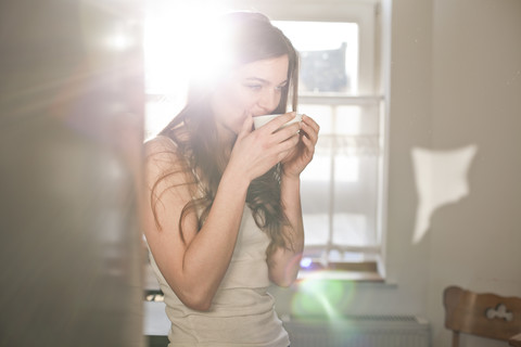 Portrait of young woman drinking tea in the morning stock photo