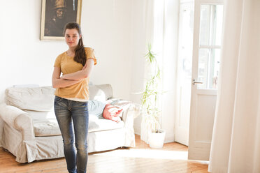 Young woman standing in her living room - FEXF000192