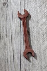 Screw wrench made of chocolate lying on grey wood - CSF022011