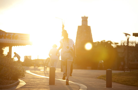 France, Aquitaine, Seignosse, people walking at backlight stock photo