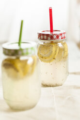 Two screw-top jar of chia fresca, mexican lemonade with chia seeds, Salvia hispanica - SBDF001121