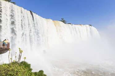 Brasilien, Parana, Iguazu National Park, Touristen stehen auf einer Aussichtsterrasse vor einem Wasserfall - FOF006682