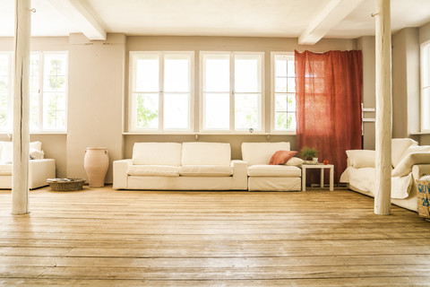 Spacious living room with wooden floor stock photo