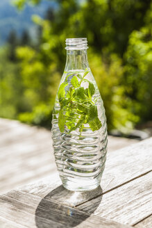 Bottle of water with mint leaves - TCF004157
