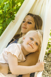 Mother and daughter relaxing in hammock - TCF004163