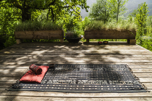 Blanket with cushion on wooden terrace - TCF004176