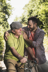 Portrait of father and son laughing together - UUF001534