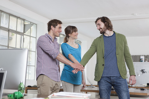 Three colleagues in an office stock photo