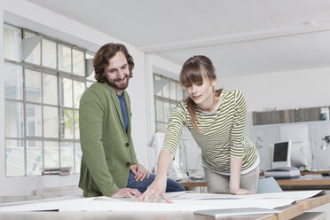 Two colleagues looking at conception in a creative office - RBF001783