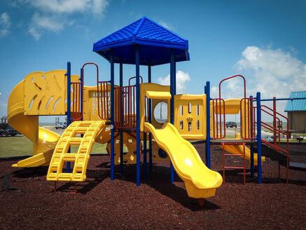 Jungle gym with several slides on a public children's playground, Texas, USA - ABAF001448