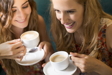 Two female friends having fun in a coffee shop - FCF000384