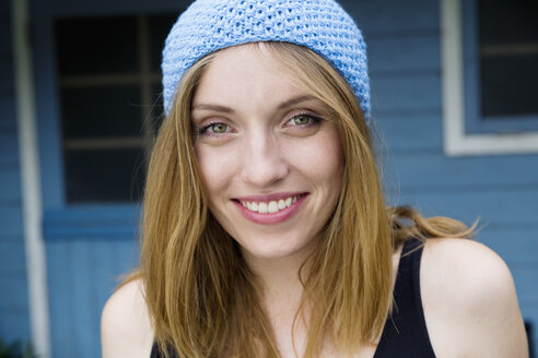 Porträt einer lächelnden jungen Frau mit hellblauer Mütze - SEF000811
