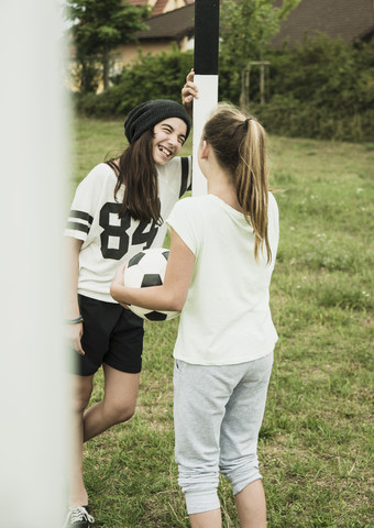 Two young girls having fun on a soccer field stock photo