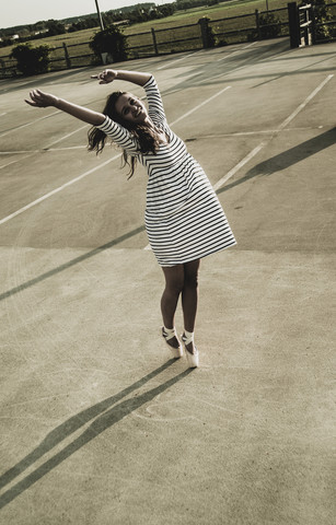 Young ballet dancer exercising on a parking level stock photo