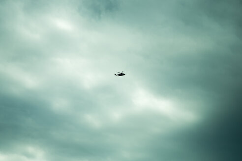 Norway, helicopter in cloudy sky - NGF000131