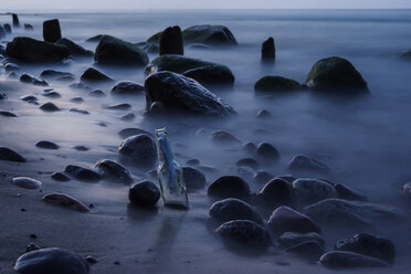 Germany, Mecklenburg-Western Pomerania, Ruegen, Message in a bottle at beach - PAF000734