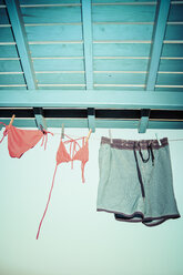 Greece, bikini and trunks drying on a washing line - KRPF000865