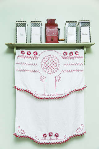 Embroidered cloth and sotrage vessels in kitchen stock photo