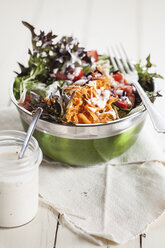 Bowl of mixed salad and glass of yoghurt salad dressing - SBDF001228