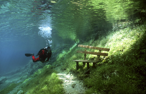 Austria, Styria, Tragoess, lake Gruener See, diver in front of a park bench stock photo