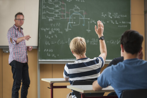 Vocational school students in classroom with teacher at blackboard - PAF000840