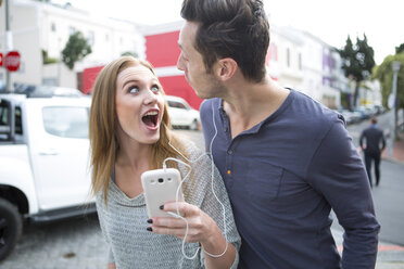 Young couple listening music with earphones - ZEF000011