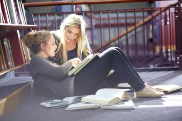 Two female students learning in a library - ZEF000102