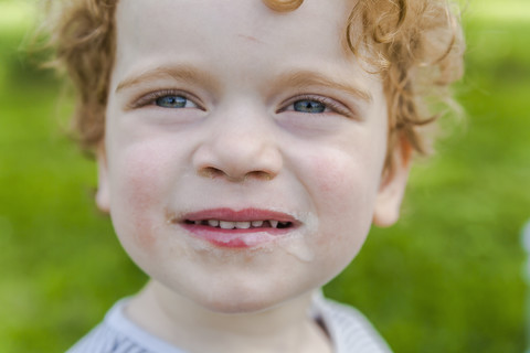 Portrait of smiling little boy covered with ice cream stock photo