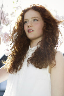 Portrait of girl with curly red hair wearing white dress - GDF000411