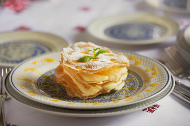 Orange creme and slices of filo pastry on plate - KMF001415